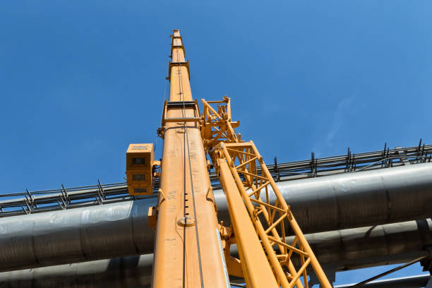 istock Boom of the large yellow construction crane is stretched high 1023335498