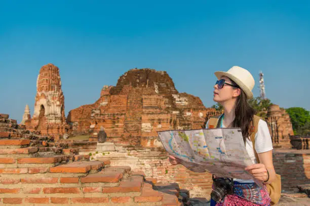 Photo of woman looking up her map at attraction