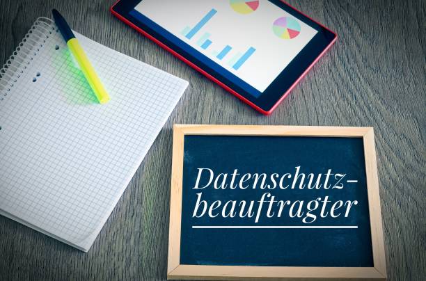 istock Plate with the inscription in german Datenschutzbeauftragter  in English  data protection commissioner with a tablet and block to signal typical activities of data protection officers 1023338714