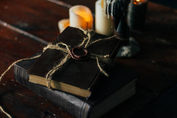 istock old book on a wooden table by candlelight 1023352998