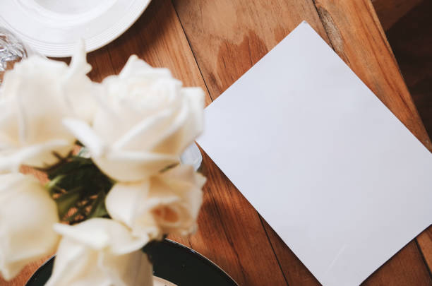 istock Roses on table with paper in vase retro style 1023361958