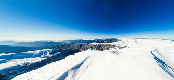 istock Panoramic winter mountains sunny landscape aerial view 1023364398