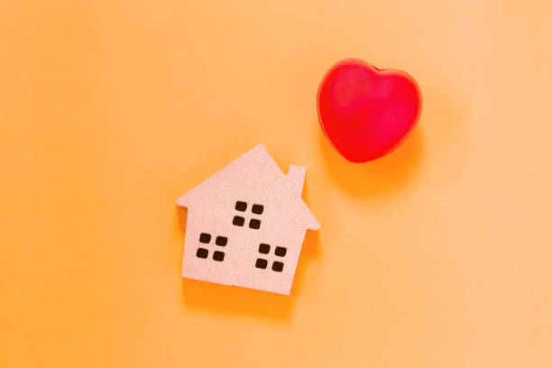 istock home shape wood and heart 1023365054