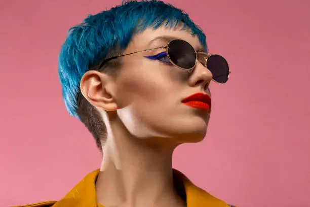 Blue hair girl in sunglasses wearing yellow jacket