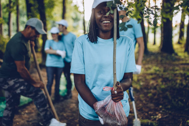 istock Volunteers planting tree in the park 1023375228