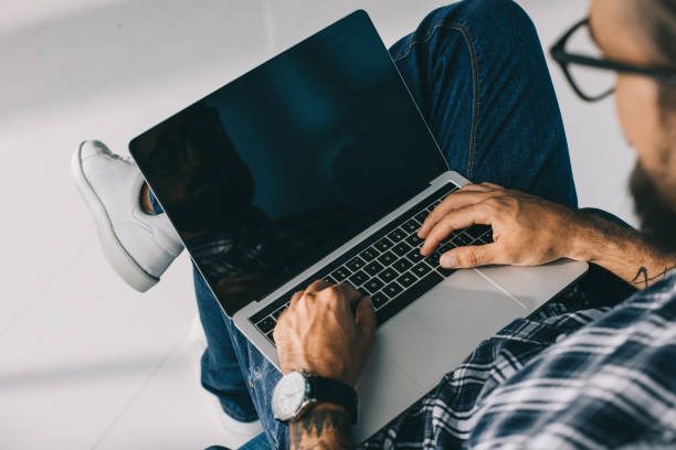 istock cropped view of man using laptop with blank screen 1023378924