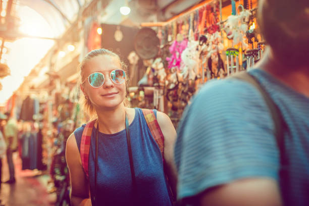Couple discover souvenirs market while travelling