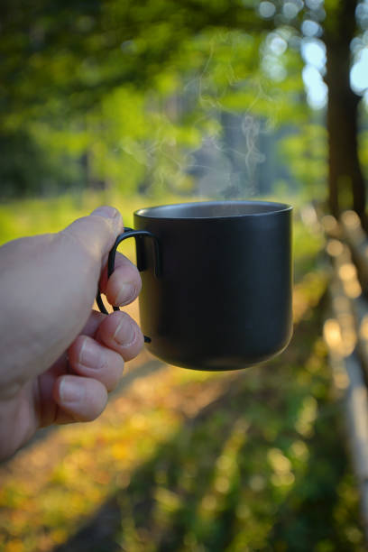 istock Man hand drinking coffee in morning outdoor 1023388316