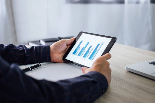 istock Professional at work, businessman using tablet working analysis investment connection at modern workplace 1023391344