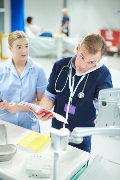 istock trainee nurse with ward doctor 1023393512