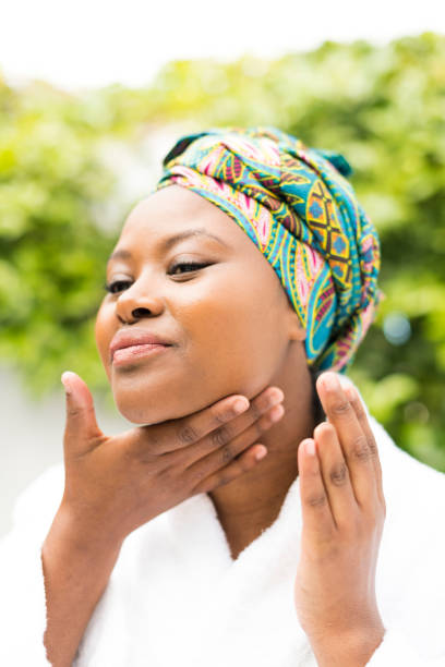 istock Young woman applying moisturizer to her skin 1023393610