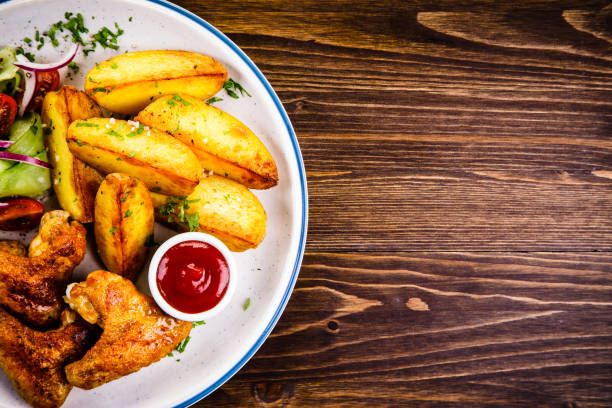 istock Chicken wings and vegetables 1023397938