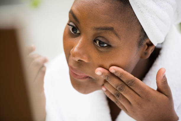 istock Beautiful young woman applying make up in the bathroom 1023401652