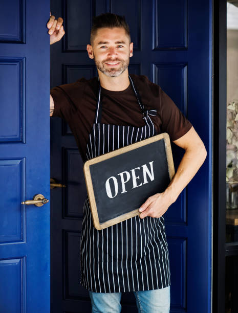 istock A cheerful small business owner with open sign 1023405152