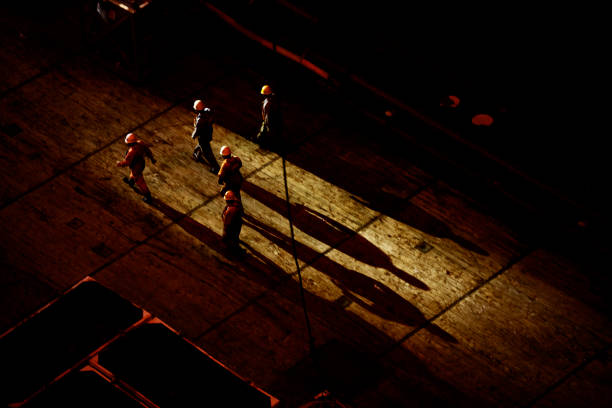 shadows of roughnecks on a offshore oil rig - mining engineer oil industry construction site imagens e fotografias de stock