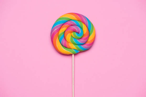 istock Rainbow lollipop swirl on wooden stick 1023417064