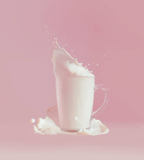 istock Splash of milk against pink background 1023421582