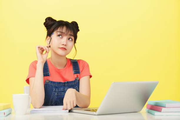 istock Dreaming young woman studying at desk 1023421726