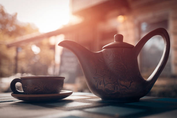 istock vintage tea kettle with cup outdoor at sunset; 1023422606