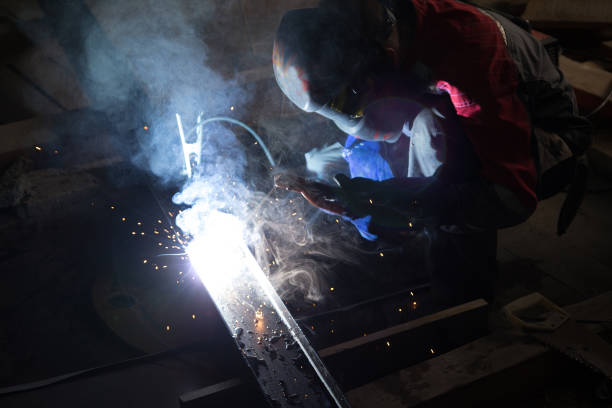 istock Welder in a protective suit and mask at work 1023433200