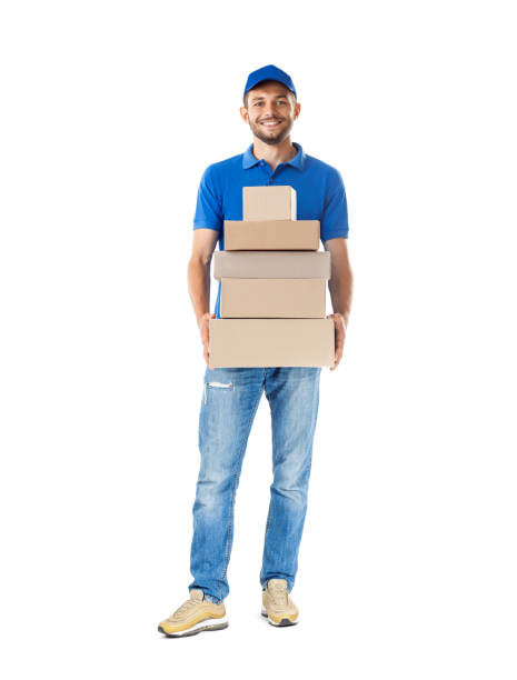 istock Smiling young male postal delivery courier man with delivering package 1023438254