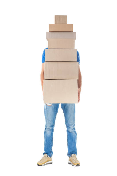 istock Delivery man hiding behind large stack of cardboard boxes 1023438276