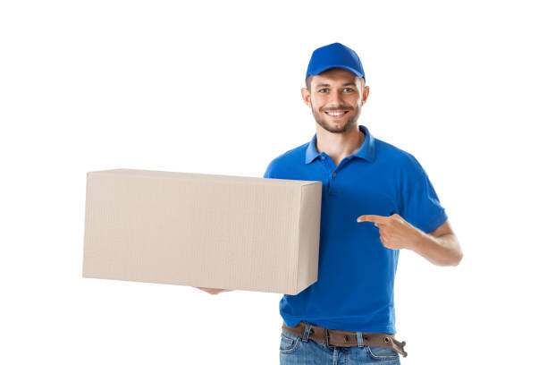 istock Happy postman shows on big box isolated on white background 1023438296