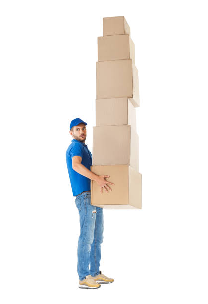 istock Full length profile portrait of courier  carrying stack of boxes 1023438336