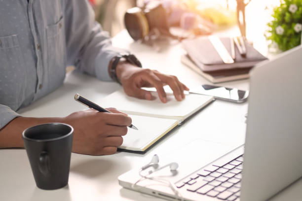 istock Cropped shot a Man writing on notebook paper on workplace. 1023438374