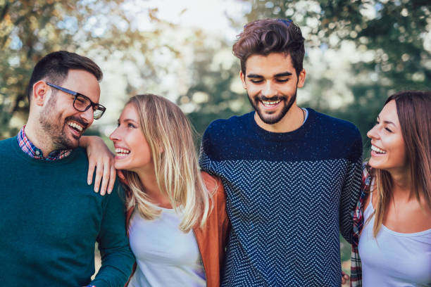istock Group of young people walking through park 1023438784
