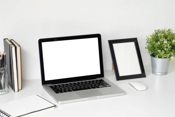 istock Workspace with Mockup laptop computer on white table with office supplies. 1023439202