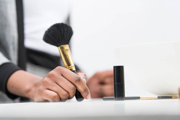 Young woman holding a make up brush