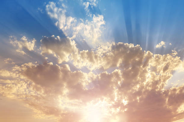 istock Sky with gray and blue clouds and red-orange highlight from the Sun 1023444624