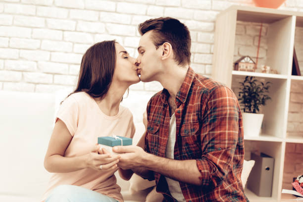 istock The guy makes a gift to his girlfriend on Valentine's Day. 1023450900