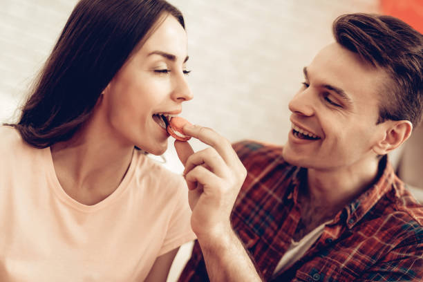 istock Guy Feeds Girlfriend With Sweet. Valentine's Day. 1023451018