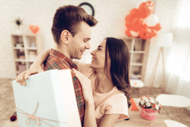 istock Guy Makes A Gift To Girlfriend On Valentine's Day. 1023451050