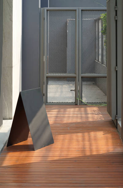 istock Simple black metal triangle for signage on the timber floor 1023455916