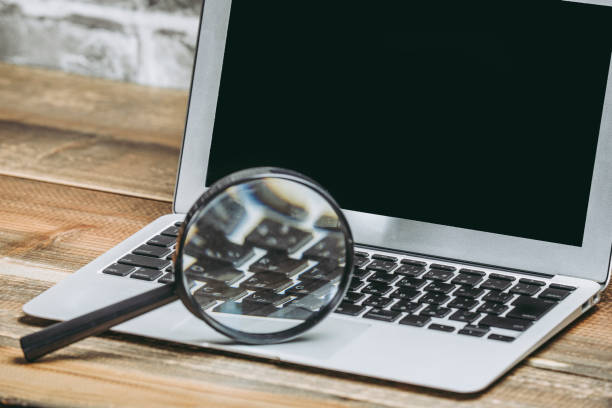 istock Magnifying glass and laptop 1023455944