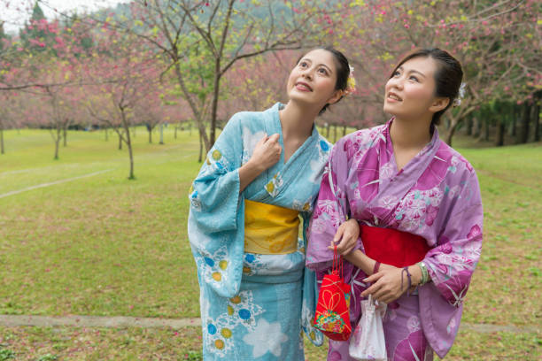 istock Two young Asian girls stand walking together 1023456162