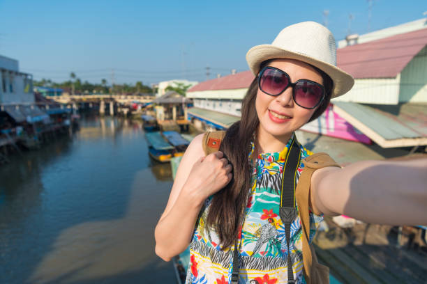 istock woman standing at the float market background 1023456886