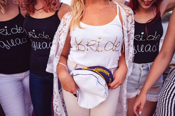 Ladies celebrating bachelorette party Bride and bridesmaids wearing shirts with inscription on celebration of hen party on the boat. bachelor and bachelorette parties stock pictures, royalty-free photos & images