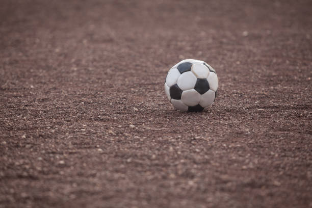 istock Soccer Ball On Dirt Ground 1023469060