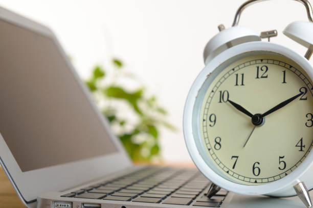 istock Alarm Clock and laptop 1023469388
