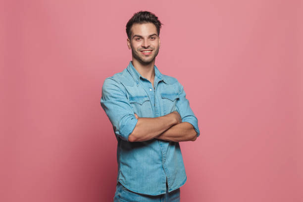 istock portrait of confident casual man standing with hands folded 1023471604