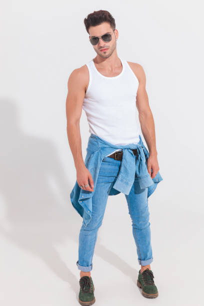 istock casual man wearing white undershirt and sunglasses stands in spotlight 1023471878