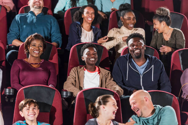 istock Multi-ethnic audience watching movie in theater 1023472038