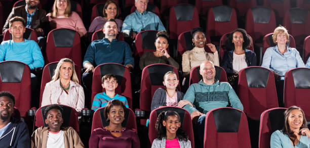 istock Multi-ethnic audience watching movie in theater 1023472208