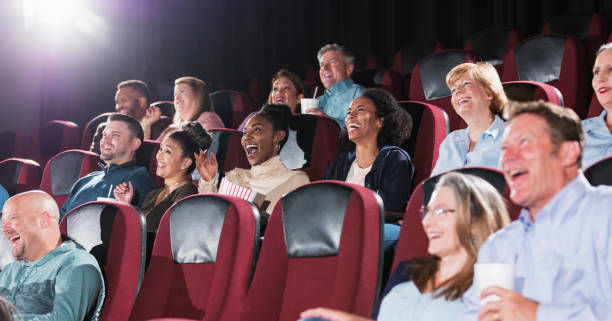 istock Multi-ethnic audience in a movie theater, laughing 1023472498
