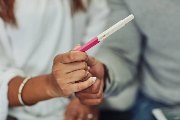 We're having a baby Closeup shot of an unrecognizable couple holding a pregnancy test at home ovulation stock pictures, royalty-free photos & images