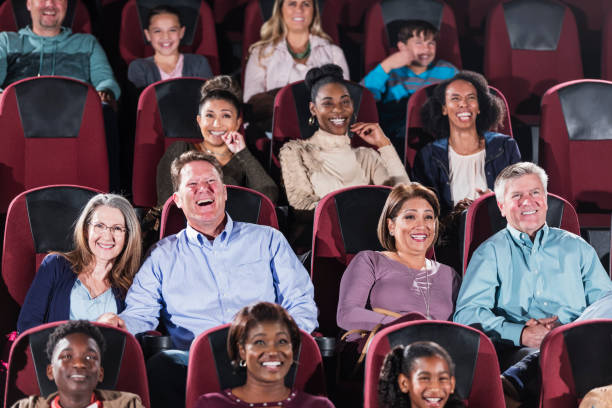 istock Multi-ethnic audience watching movie in theater 1023472904